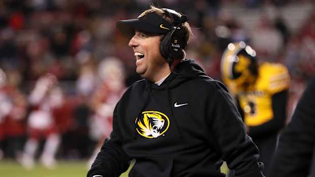 Nov 24, 2023; Fayetteville, Arkansas, USA; Missouri Tigers head coach Eli Drinkwitz celebrates after a defensive touchdown in the third quarter against the Arkansas Razorbacks at Donald W. Reynolds Razorback Stadium. Missouri won 48-14. Mandatory Credit: Nelson Chenault-USA TODAY Sports  